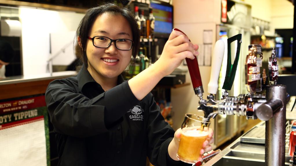 Yue Ma pours a beer at the Welcome Stranger.
