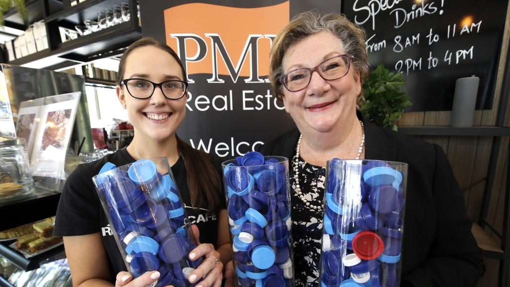 PMM Real Estate and Rhyme Street Cafe have joined forces to collect milk container tops to be used in prosthesis joints. PMM Senior Property consultant, Michelle Blom (right) and Rhyme Street Cafe team member, Willow Wright with some of the plastic bottle tops they have collected. Picture: ROGER LOVELL
