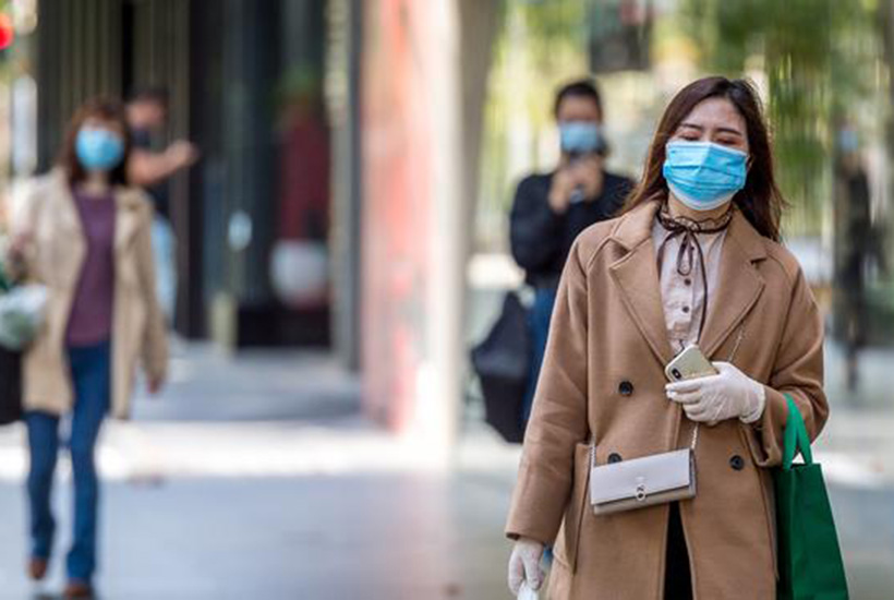 People wear masks walking through Melbourne’s CBD. Picture: Jake Nowakowski
