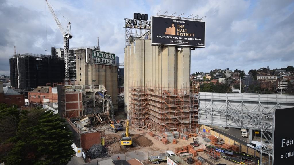 Cladding is appearing around the base of several silos at Cremorne’s $1 billion The Malt District redevelopment by Caydon.
