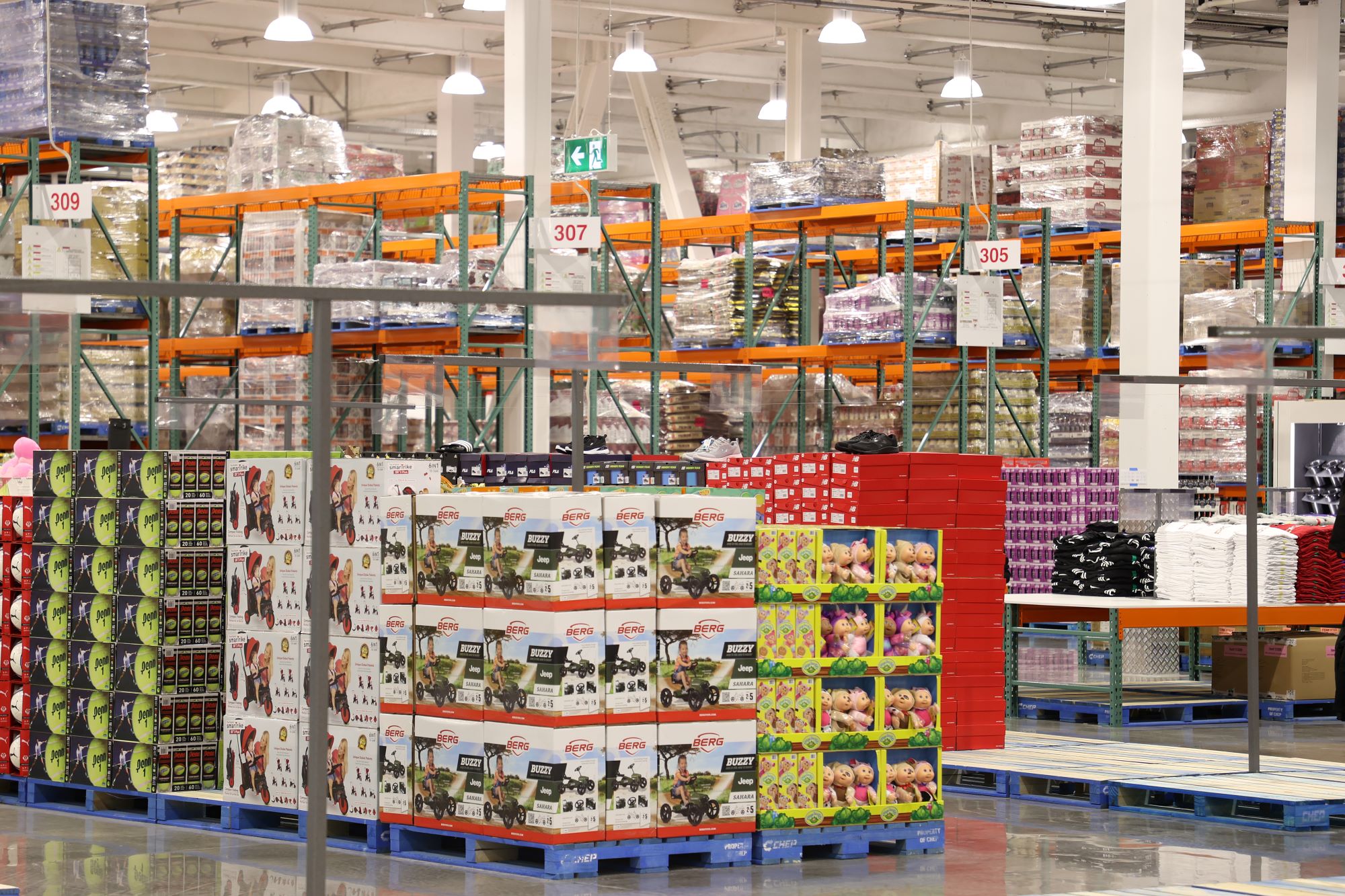 Toys and sporting goods stacked on pallets in Costco's first New Zealand store.