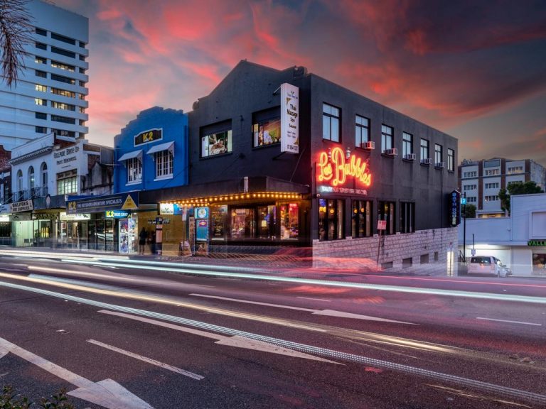 Notorious Les Bubbles building for sale with history all over its walls