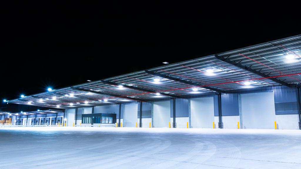 Illuminated exterior of a factory, industrial style building. Night time.Illuminated exterior of a factory, industrial style building. Night time.