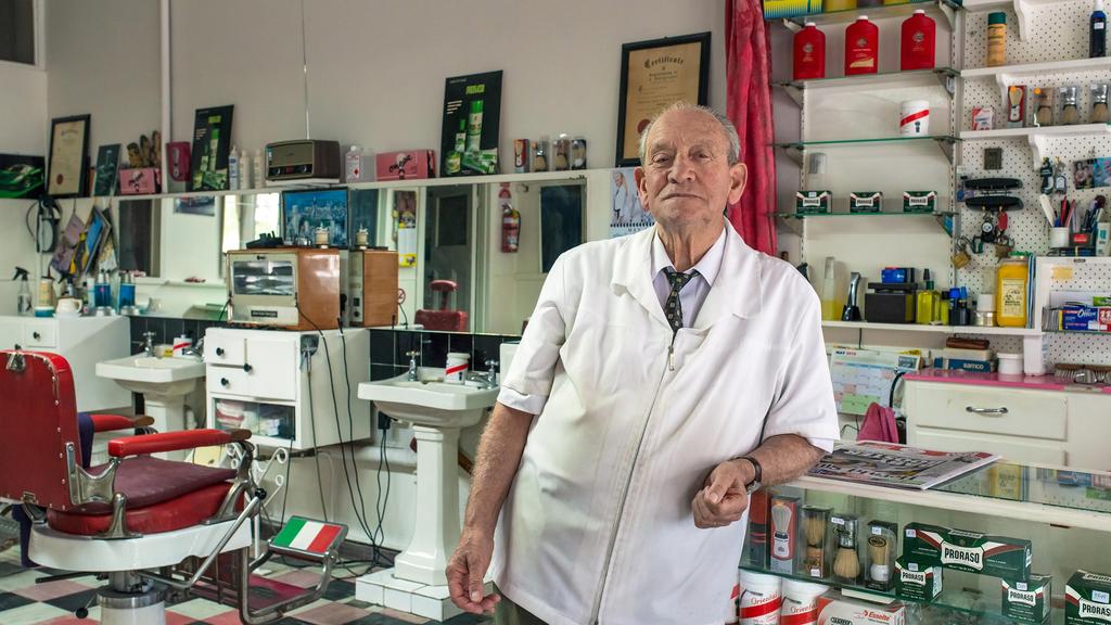 Now retired barber Raffaele Mucilli in his barbershop, Sunshine - for herald sun real estate. Must credit to: Warren Kirk. NOTE; ONE-TIME USE ONLY