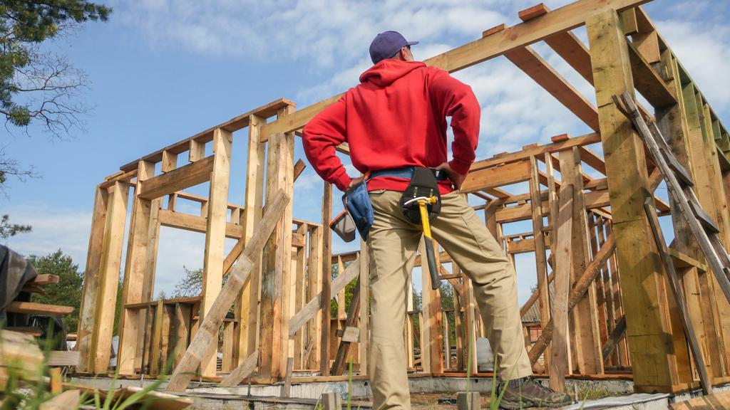 roofer ,carpenter working on roof structure at construction site