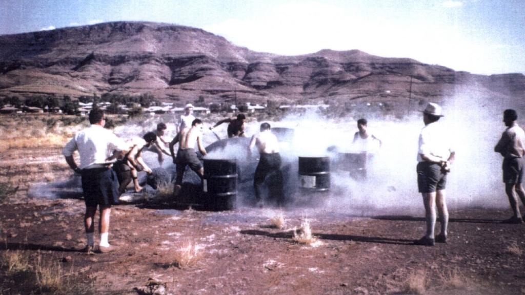04/02/2005 PIRATE: 1962 : Arthur Della Maddalena and workmates shovel raw blue asbestos tailings into drums at an asbestos shovelling competition at Wittenoom, in the Pilbara, WA, in 1962. The mean are (L-R)Tony Uchanski, unknown, unknown, Peter Pas, Arthur Della Maddalena, unknown, Joe Piwowarcyk, Brian Bolitho, Gienek Jaworski and Stan Kruchowski. in 2005 four are known to be dead and three fighting asbestos-related diseases. The fate of the other three is unknown.
Western Australia / Industry / Mining
Historical