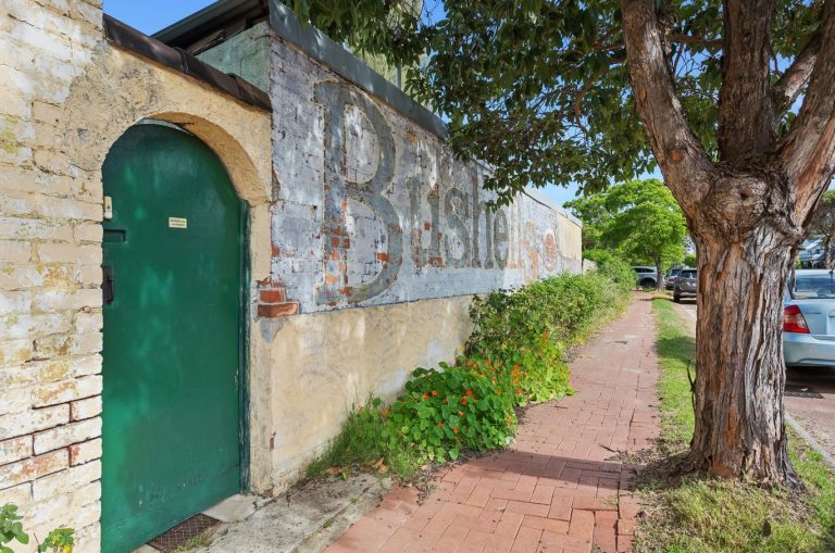 Hundreds swarm historic Bushells tea building with iconic ‘ghost sign’