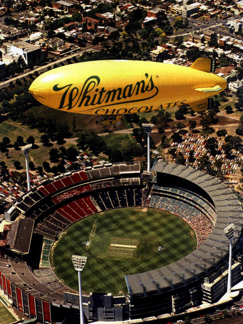 Whitman's Chocolates sponsored airship owned by Lightship Group soars above Melbourne Cricket Ground (MCG). 1996.
Advertising / Chocolate / Confectionery
Victoria / Aviation / Blimp