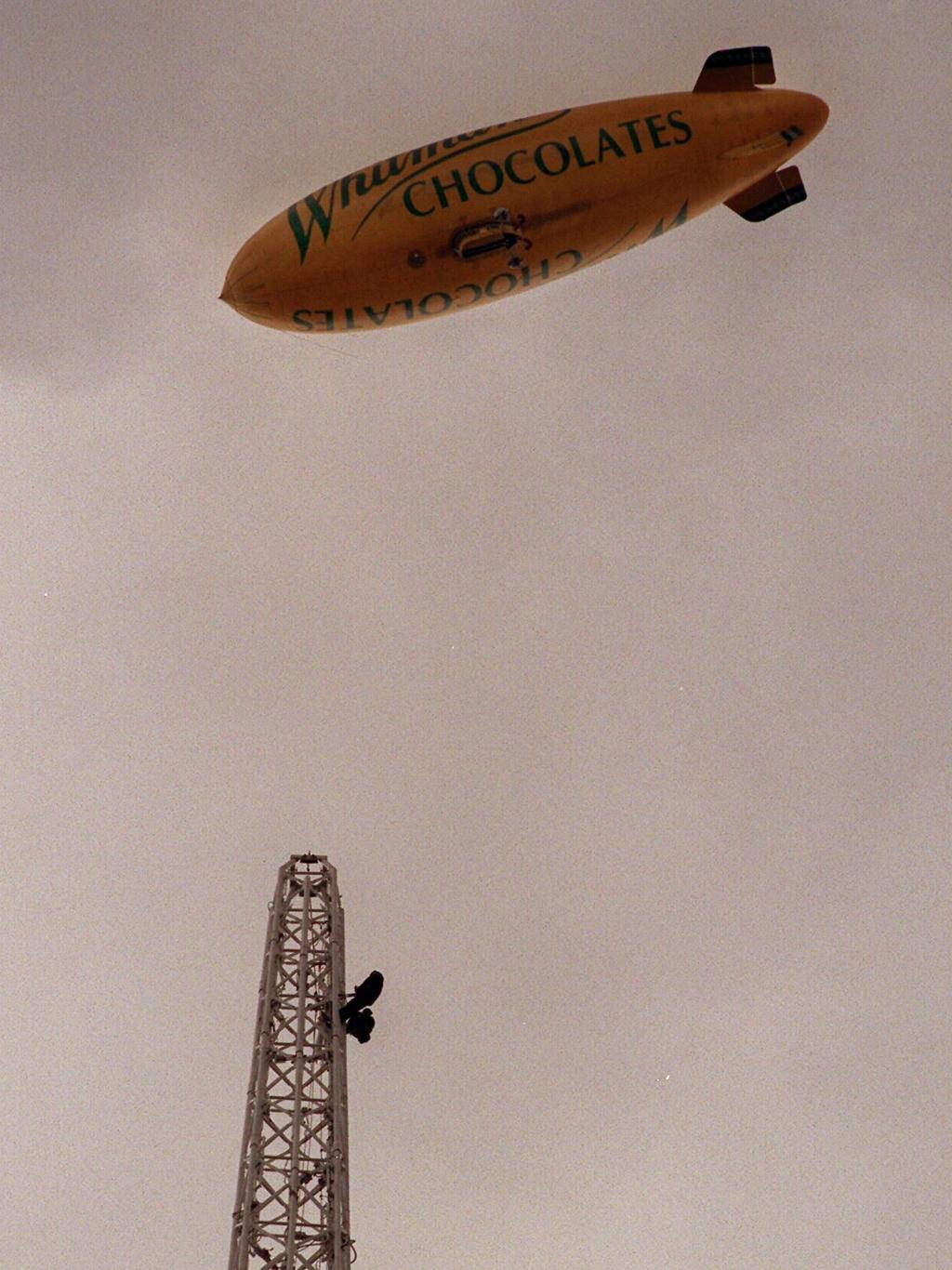 The Whitman's Lightship (blimp) flies over the top of the Arts Centre as there are two people on the outside of the tower. 27 September 1996.
/aircraft