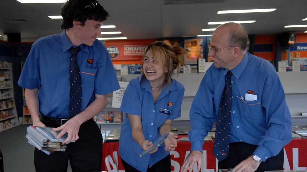 Kevin Rudd supporter, John Lochens at his Video Ezy store at Menai. With young workers Cindy Puertas,20 and Daniel Lochens,18.