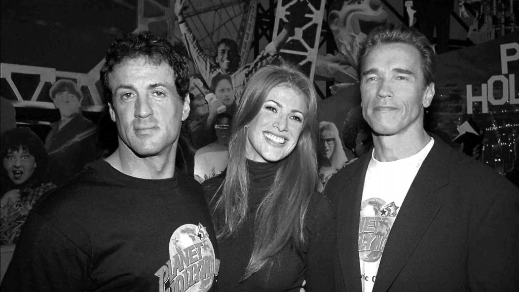 (L-R) Actor Sylvester Stallone, model Angie Everhart & actor Arnold Schwarzenegger at opening party at Planet Hollywood in Atlantic City, New Jersey 22/04/95 Stallone & Schwarzenegger, principal shareholders in restaurant.                           Entertainment / With Others           General